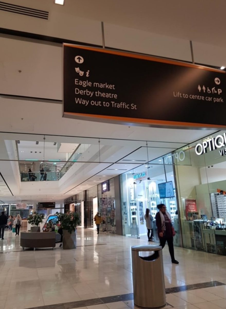 Direction sign. White print on black background