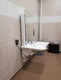 Electric adjustable sink in changing place toilet